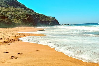 Scenic view of beach against clear sky