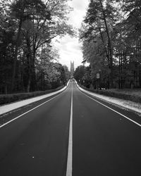 Empty road along trees