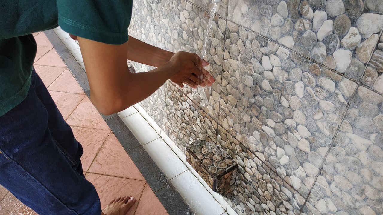 LOW SECTION OF MAN STANDING ON STONE