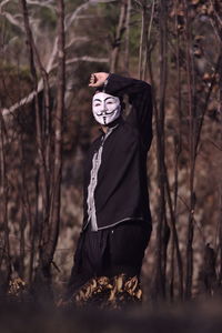 Man wearing mask in forest