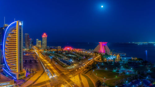 Illuminated buildings in city at night
