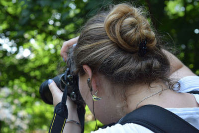 Side view of woman with camera 