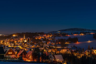 High angle view of illuminated buildings in city at night