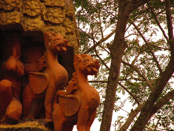 Low angle view of statue against trees