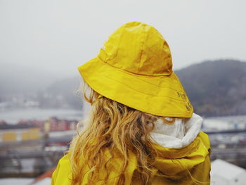 Rear view of woman standing against sky