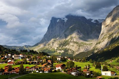 Houses in town against cloudy sky