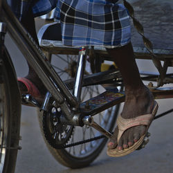 Low section of man with bicycle on street