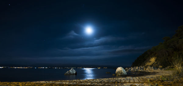 Scenic view of sea against sky at night