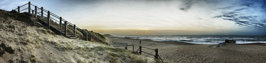 Scenic view of beach against sky during sunset