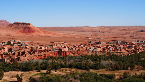 Scenic view of residential district against clear blue sky