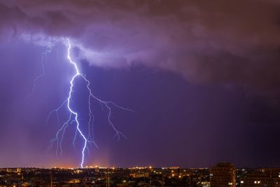 Lightning over cityscape at night