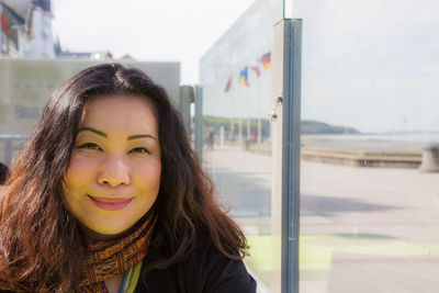 Portrait of smiling young woman standing outdoors