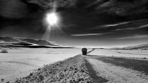 Over burdened truck by snow covered field