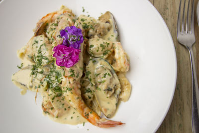 Close-up of seafood in plate on wooden table