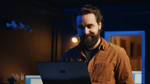 Young man using laptop at home