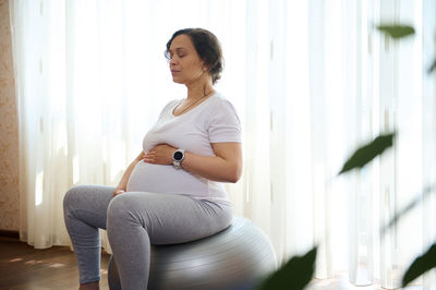 Young woman exercising at home