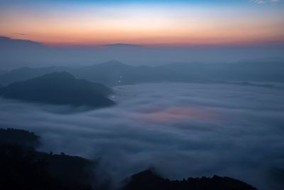 Scenic view of silhouette mountains against sky during sunset