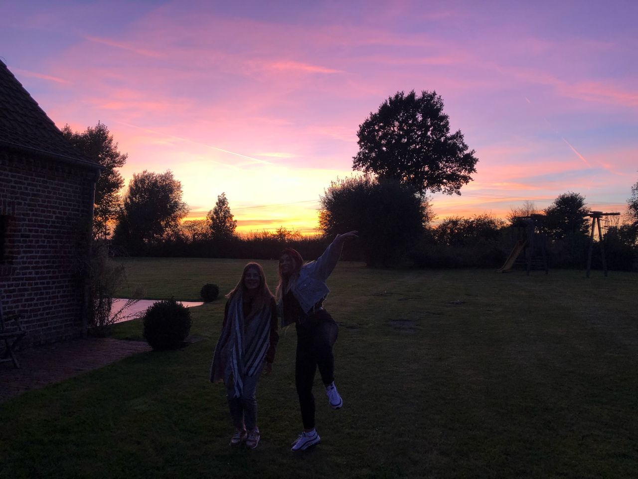 sky, sunset, plant, tree, grass, real people, cloud - sky, nature, men, leisure activity, field, group of people, land, lifestyles, women, full length, people, togetherness, orange color, outdoors