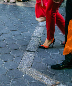 Low section of woman walking on zebra crossing