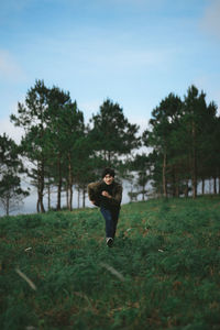 Full length of man standing on field against sky