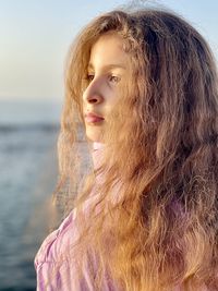 Girl with long hair looking away