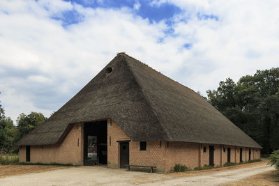 Exterior of house by building against sky