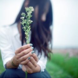 Close-up of a woman holding plant