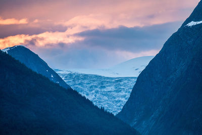 Scenic view of mountains against cloudy sky