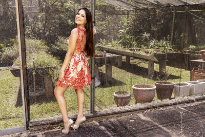 Portrait of smiling young woman standing outdoors