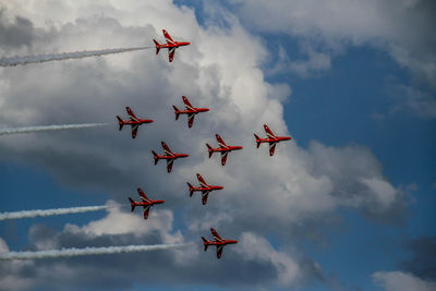 Low angle view of airshow against sky