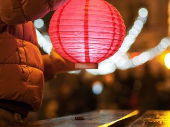 Close-up of illuminated lanterns hanging at night