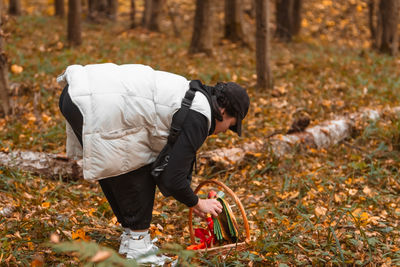 Rear view of man working in forest