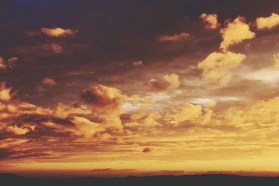 Low angle view of dramatic sky during sunset