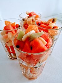 Close-up of fruits in glass over white background