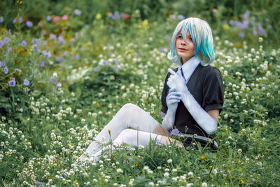 Woman sitting on top of flowering plants