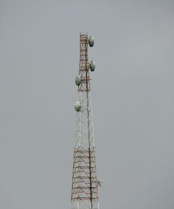 Low angle view of communications tower against sky