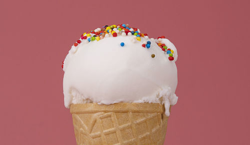 Close-up of ice cream against red background