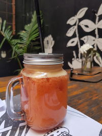 Close-up of drink in glass jar on table