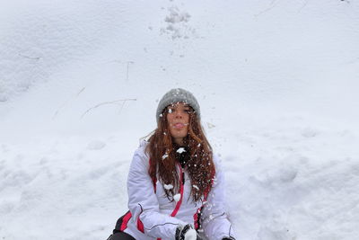 Woman standing on snow covered land