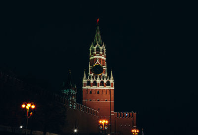 Low angle view of illuminated building against sky at night