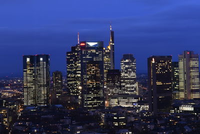 View of skyscrapers lit up at night