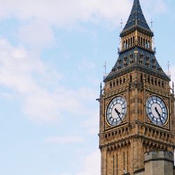 Low angle view of clock tower against cloudy sky