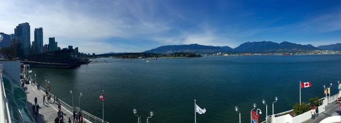 Panoramic view of sea and buildings against sky