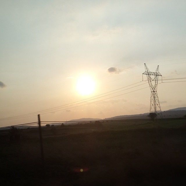 electricity pylon, sunset, power line, electricity, power supply, fuel and power generation, sun, sky, connection, technology, silhouette, cable, tranquility, tranquil scene, landscape, scenics, nature, beauty in nature, sunlight, outdoors