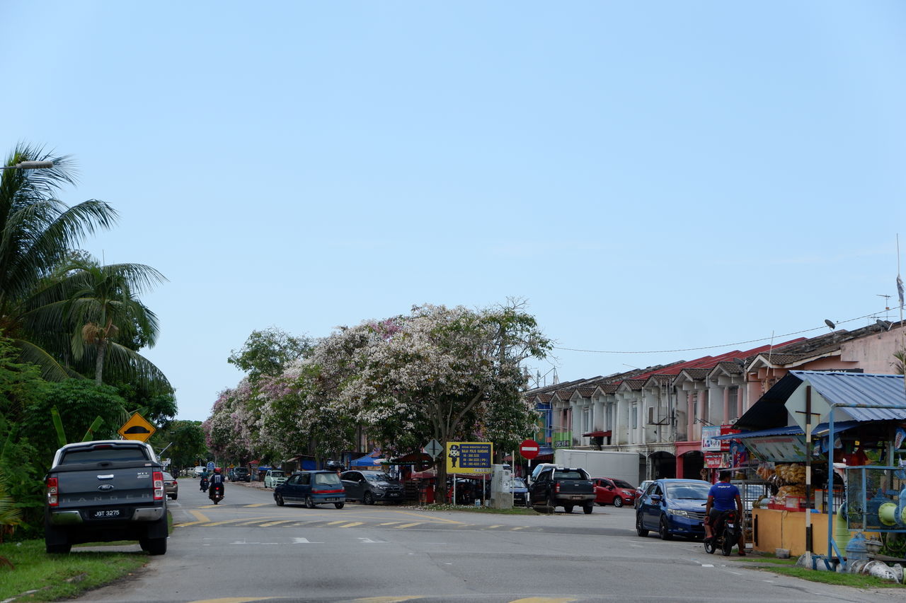 VEHICLES ON ROAD AGAINST SKY