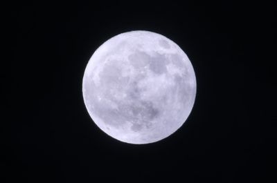 Low angle view of moon against sky at night