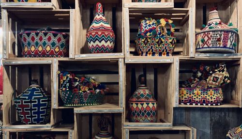 Close-up of multi colored containers on shelves