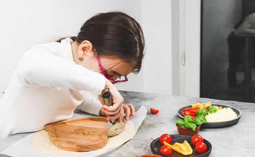 Side view of boy eating food at home