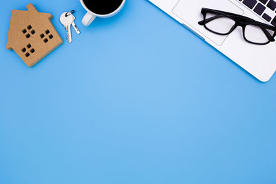 High angle view of pen on table against blue background