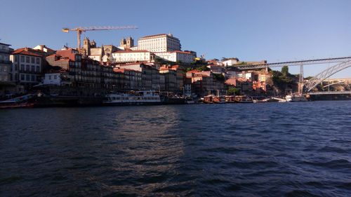 View of town by river against clear sky